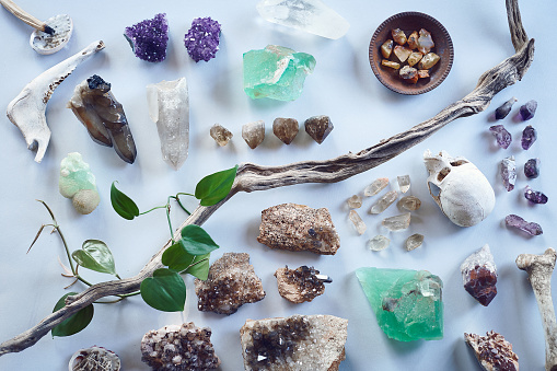 High angle shot of a table filled with different types of crystals inside during the day