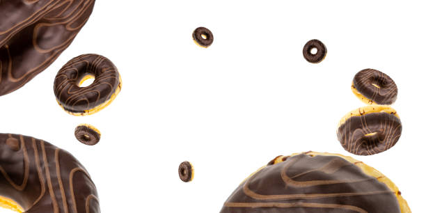 istock Sweet icing sugar food. Chocolate sweet fresh donuts flying on white. 1205685926