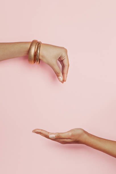 istock Taking and giving woman hands on pink background. Young womans hand presenting 1205687024