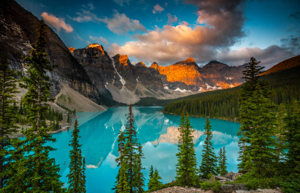 Moraine Lake Sunset, Banff National Park, Canada Moraine Lake in Banff National Park at sunset. Mountains of famous Ten Peaks reflecting in the beautiful calm turquoise water of the lake. Banff National Park, Alberta province in Canada. moraine lake stock pictures, royalty-free photos & images