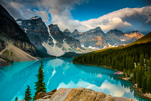 Lake Moraine in Banff National Park. Mountains of famous Ten Peaks reflecting in the beautiful calm turquoise water of the lake. Banff National Park, Alberta province in Canada.