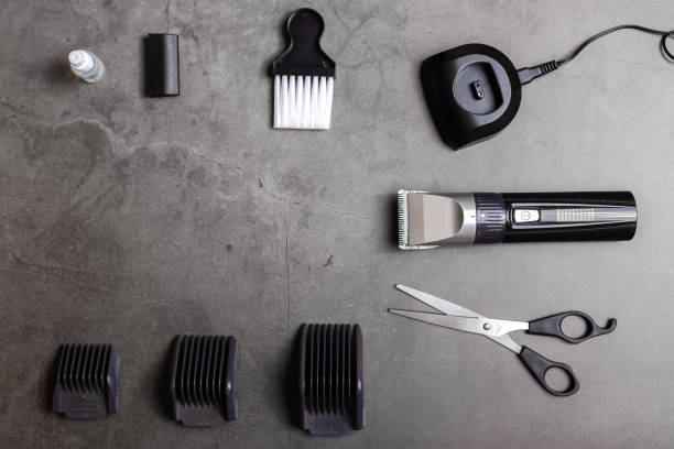 istock Hair clipper with accessories over black table. 1205692059