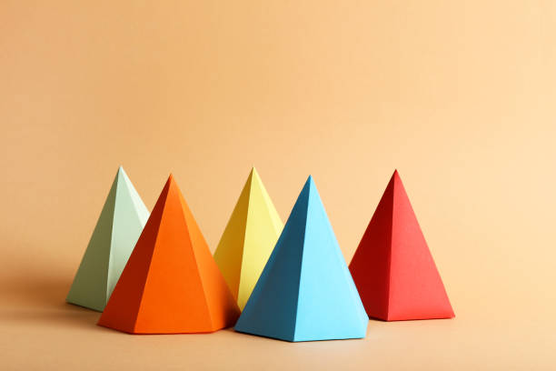 istock Colorful paper geometric figures on beige background 1205692381