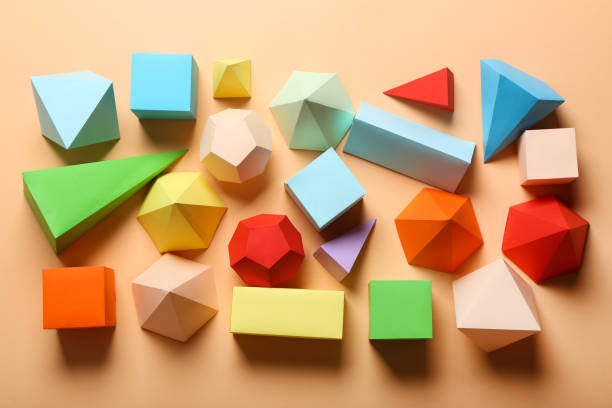 istock Colorful paper geometric figures on beige background 1205692723