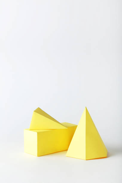 istock Yellow paper geometric figures on gray background 1205693593
