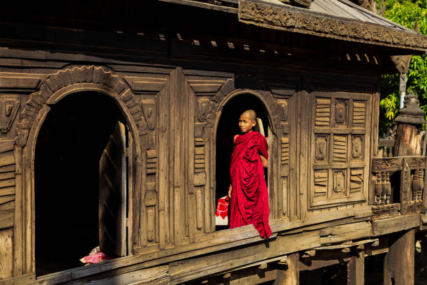 Bagan, Myanmar: Monk at Nat Taung Kyaung wooden monastery Bagan, Myanmar - Nov 16, 2019: Monk at Nat Taung Kyaung wooden monastery in Bagan, Myanmar, former Burma in Asia yoke stock pictures, royalty-free photos & images