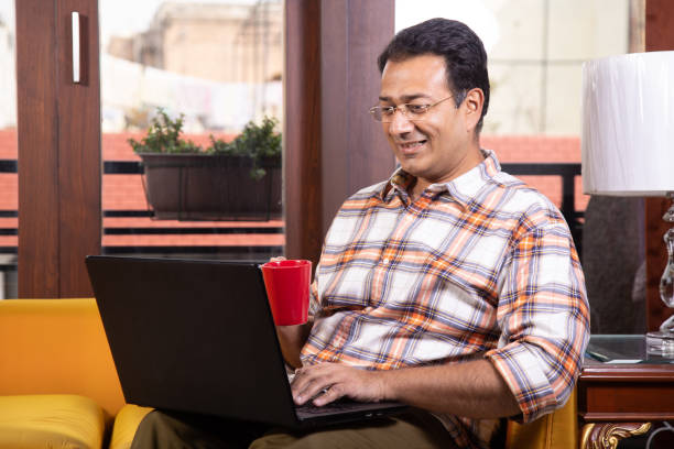 istock Man surfing net and drinking coffee at home 1205693656