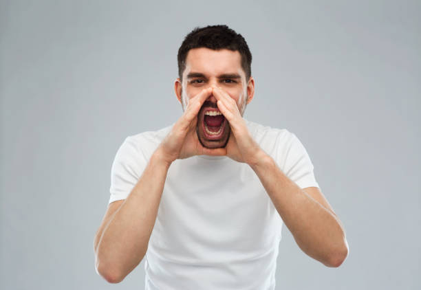 istock angry shouting man in t-shirt over gray background 1205693870