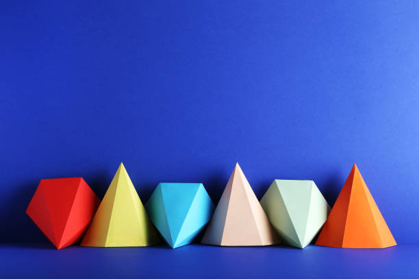 istock Colorful paper geometric figures on blue background 1205693943