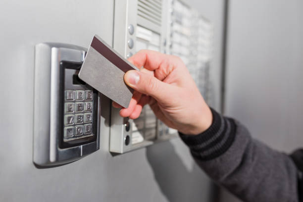 istock Man scanning security key card on electric lock to entry private building. 1205698990