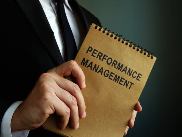 istock Manager and performance management report in the book. 1205699586