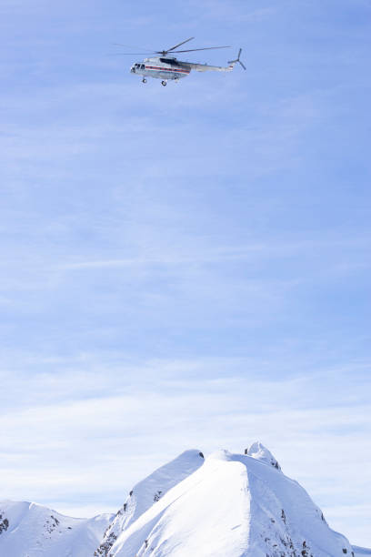 istock Russian helicopter Mil Mi-8 flying over snowy mountains. 1205700761