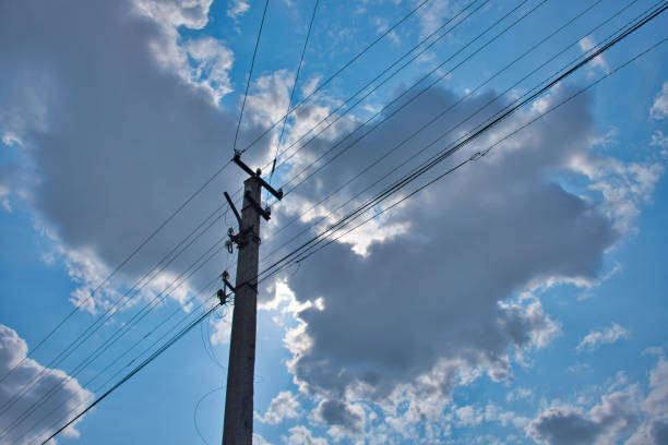 istock A pillar of power lines against a cloudy sky. 1205701690