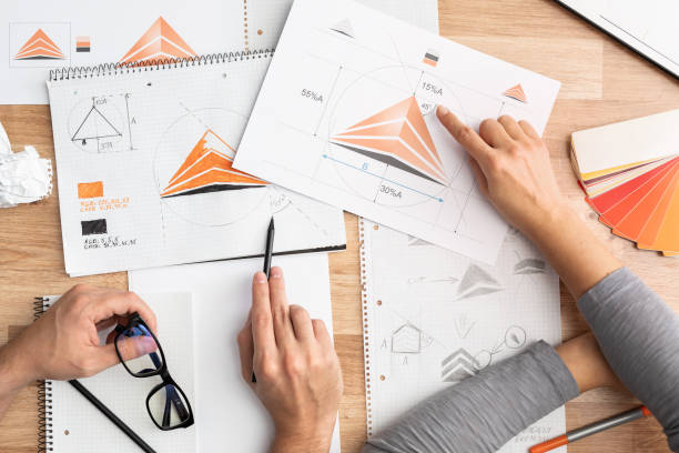 istock Graphic designer drawing sketches logo design. 1205701844