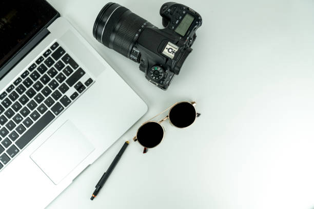 istock white Flat lay with notebook, camera, sunglasses, plants, pencil and headphones 1205701896