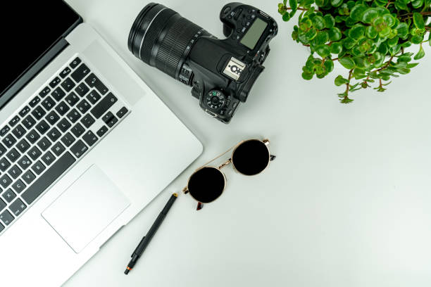 istock white Flat lay with notebook, camera, sunglasses, plants, pencil and headphones 1205701901