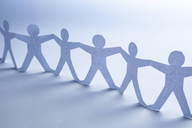 istock Human team of paper chain people. 1205701964