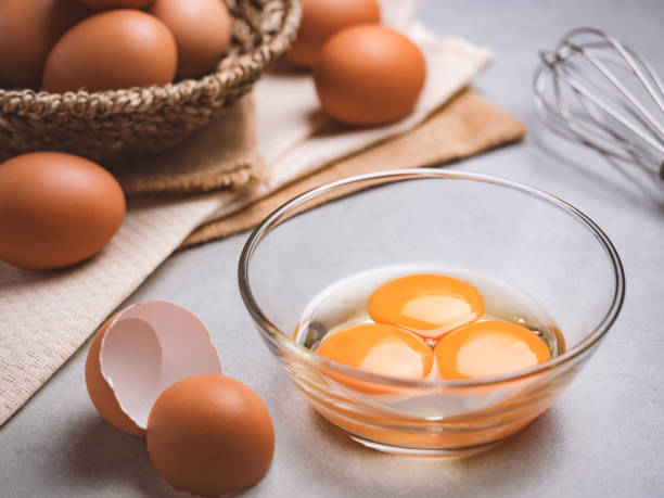 Organic chicken eggs food ingredients concept Close up image of three eggs yolk in clear bowl are one of the food ingredients on the restaurant table in the kitchen to prepare for cooking. Organic chicken eggs food ingredients concept Raw Egg stock pictures, royalty-free photos & images