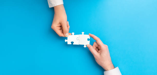 istock People holds in hand a jigsaw puzzle. Business solutions, success and strategy. 1205702651