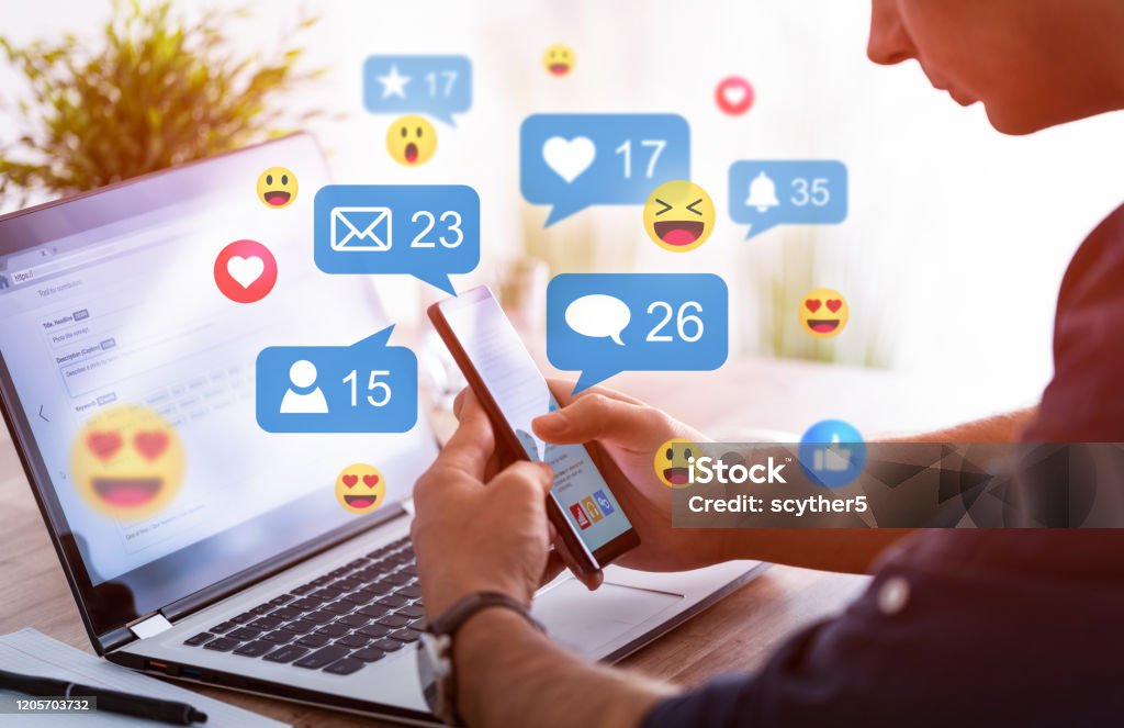 Social media concept. Like and share social media. Hands holding smartphone with social media network icons. Marketing concept. Social Media Stock Photo