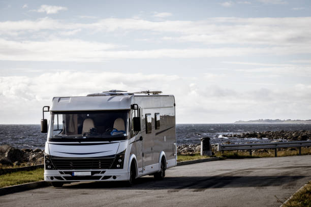 istock Camper car on coast of Norway with ocean view 1205704787