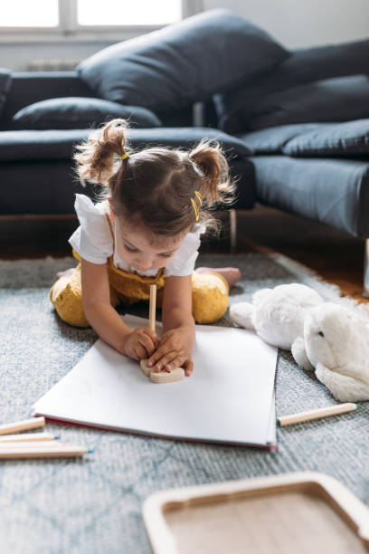 istock Girl Drawing on the Floor 1205706960