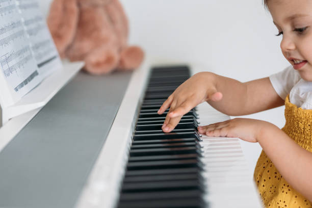 istock Cute Little Girl Playing Piano 1205706983