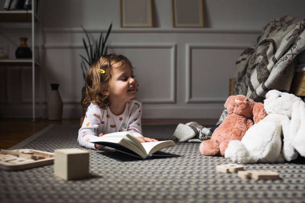 istock Little Girl Reading a Book 1205706992