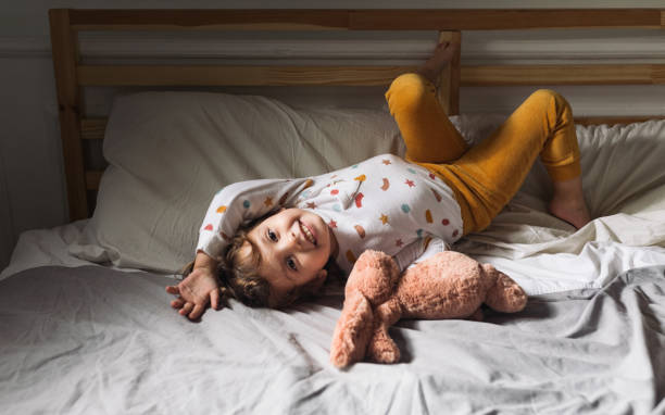 istock Little Girl Lying on Bed 1205706996