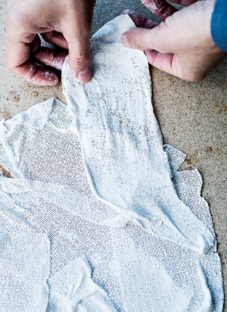 istock man working with fabric soaked in wet plaster 1205710570