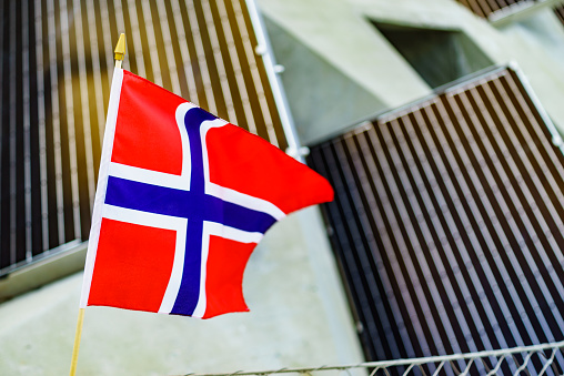 Norwegian flag waving outdoor against solar panels