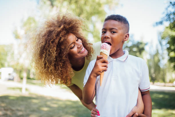 istock Cute boy eating ice cream and enjoying with mom 1205713126