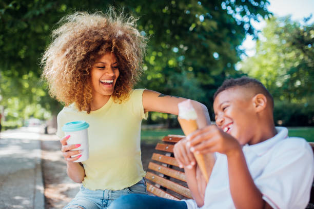 istock Mother tickling her son while enjoying in the park together 1205713131