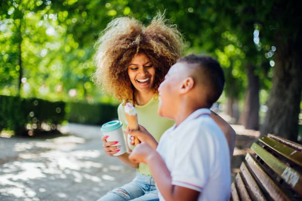 istock Woman having fun with her boy in the park 1205713140