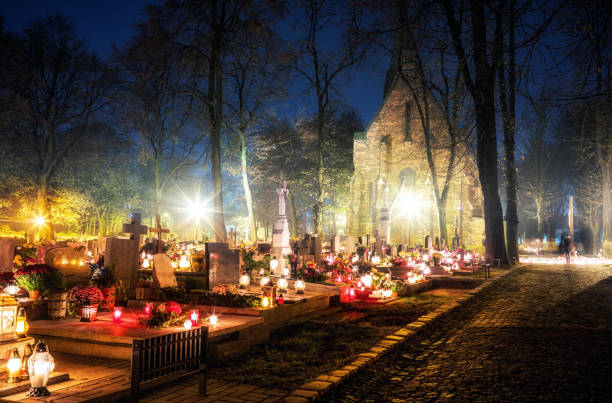 Burning candles on graves during All Saints Day Burning candles on graves during All Saints Day christian social union photos stock pictures, royalty-free photos & images