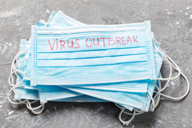 istock virus outbreak word written on medical mask. virus outbreak text on protective mask for your desing, Wuhan Coronavirus, 2019-nCoV. concept top view 1205714140
