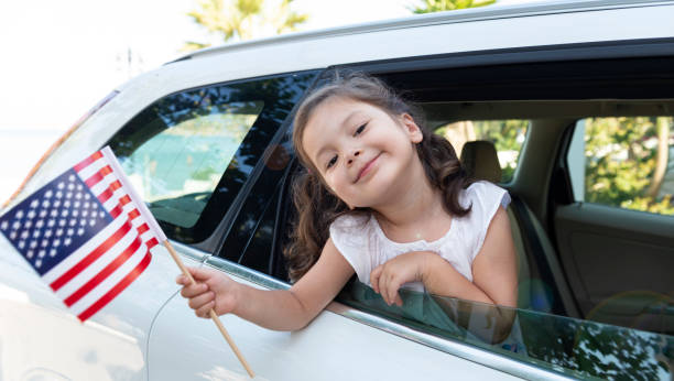istock Girl Holding American Flag 1205714902