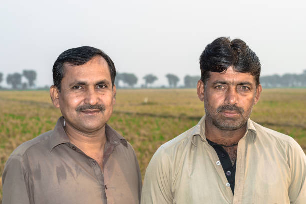 istock asian farmer is standing at his fields and smiling 1205715294