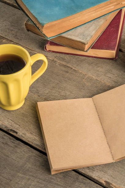 istock a blank notebook and coffee on a wooden table 1205716310