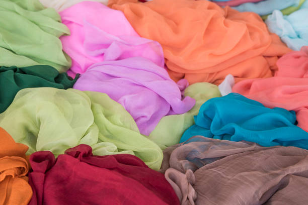 istock pile of colorful clothes, textiles as a background 1205716331