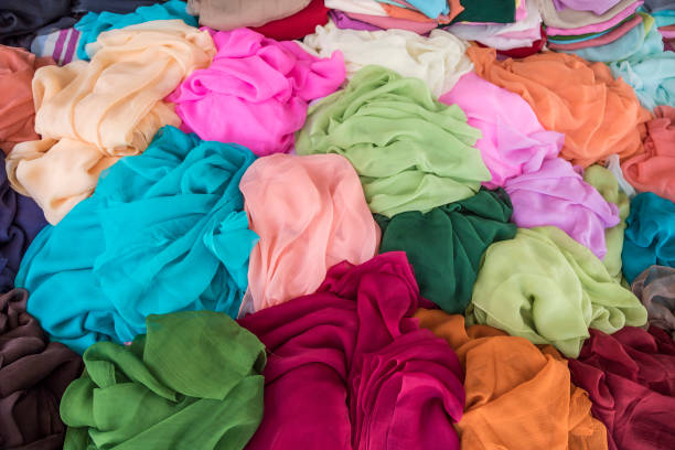 istock pile of colorful clothes, textiles as a background 1205716337