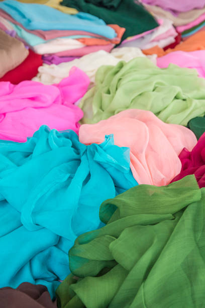istock pile of colorful clothes, textiles as a background 1205716344