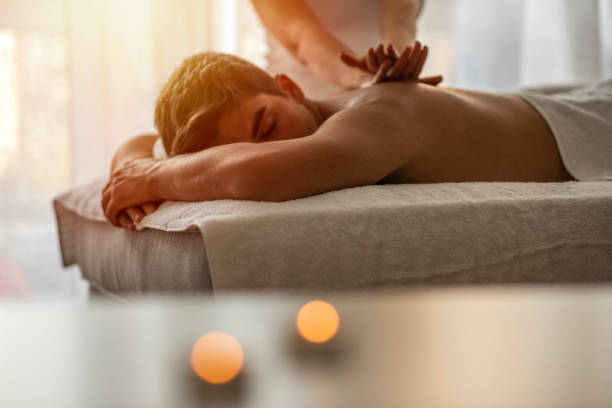 istock Close-up of masseur's hands and a client's back. 1205716617