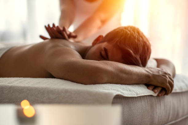 istock Young man is enjoying massage on spa treatment. 1205716644