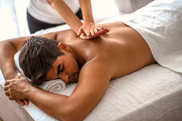 istock Man relaxing on massage table receiving massage. 1205716825