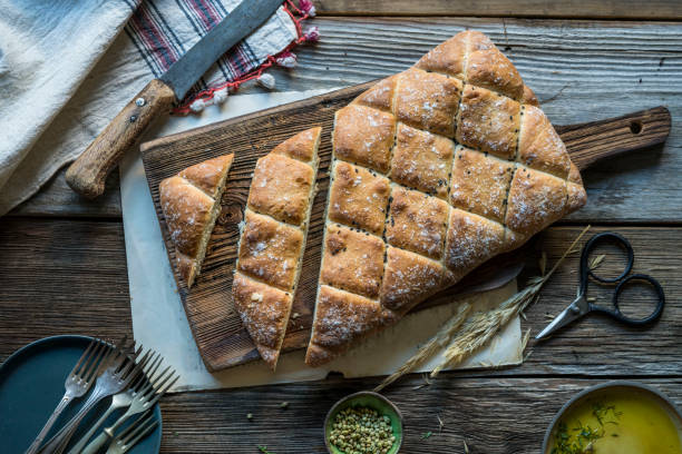 istock sliced artisan bread on wooden cutting board on table 1205717910
