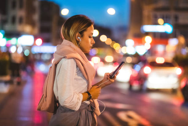 istock Young woman calling crowdsourced taxi 1205718624