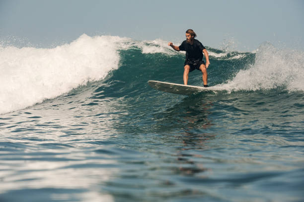 istock Surfer with beard on the board in ocean 1205718709