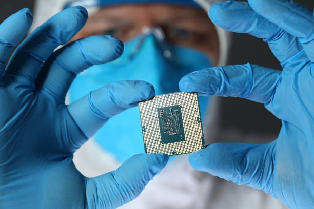 istock Close up of computer microchip in male hands 1205718786