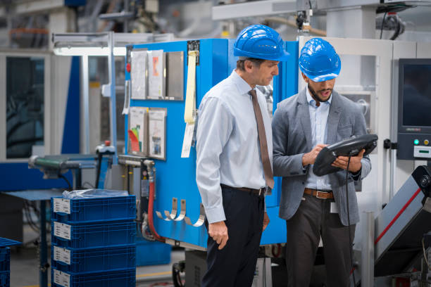 istock Engineer and supervisor discussing in factory 1205718853